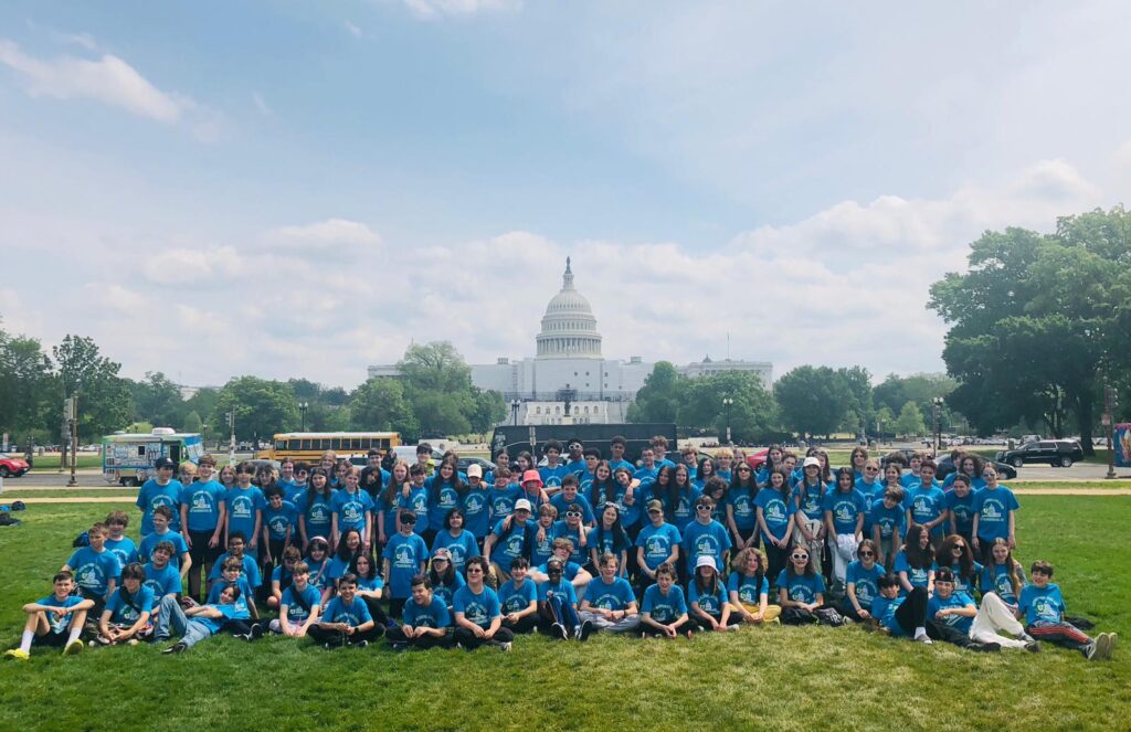 Blue Cluster students post for a group photo in front of the Capitol building in Washington, D.C.