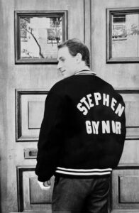 Photo of Scott Gaynor from the 90s facing away from the camera wearing a jacket that has the words "Stephen Gaynor" on the back